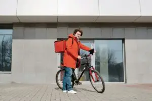 A Deliveryman Holding a Bicycle